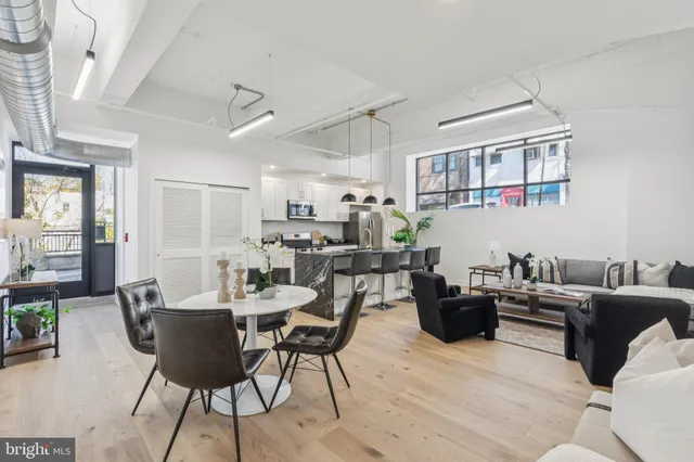a living room with furniture a rug and a table