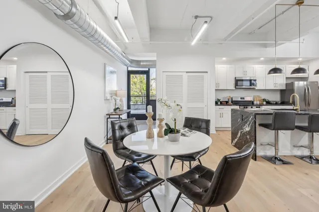 a view of a dining room with furniture and a chandelier
