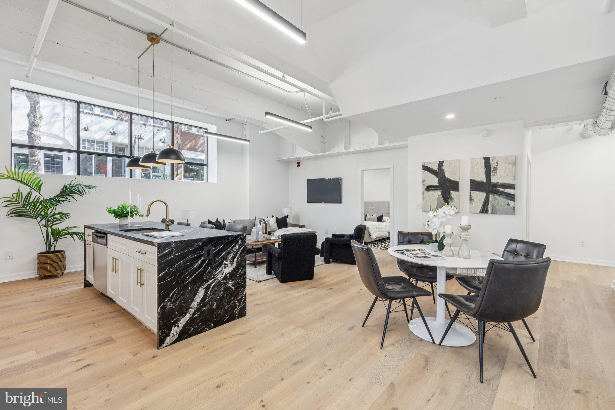 36 North Narberth Avenue, Unit 1C Narberth, PA 19072 - Photo 19 of 36 a living room with stainless steel appliances kitchen island granite countertop furniture and a wooden floor