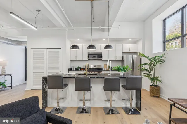 a kitchen with a table chairs stove and cabinets