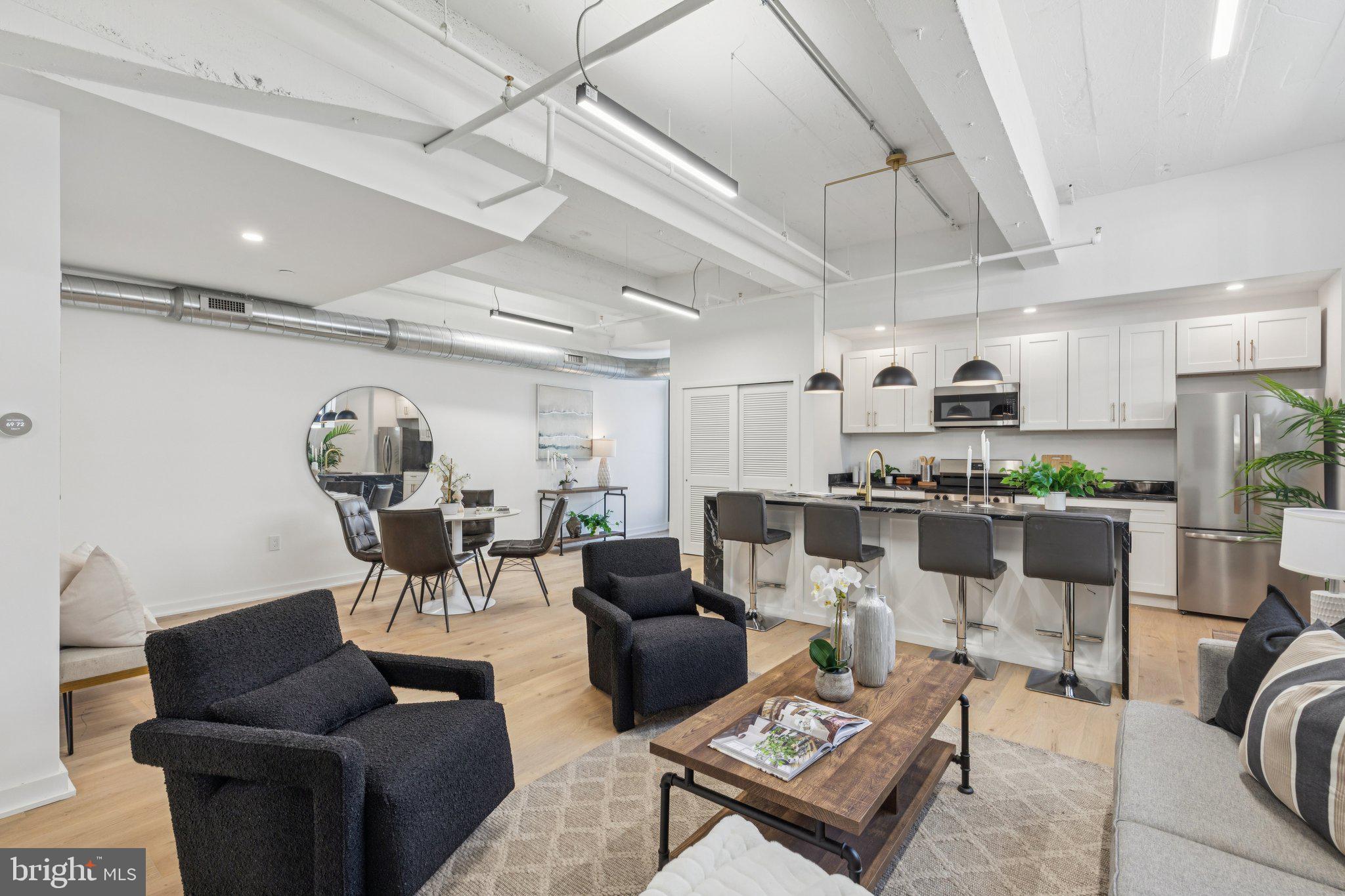 36 North Narberth Avenue, Unit 1C Narberth, PA 19072 - Photo 25 of 36 a living room with lots of furniture and kitchen view