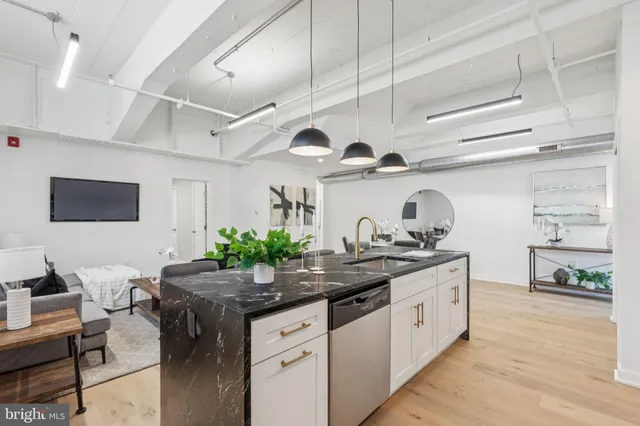 a kitchen with stainless steel appliances granite countertop a sink and cabinets