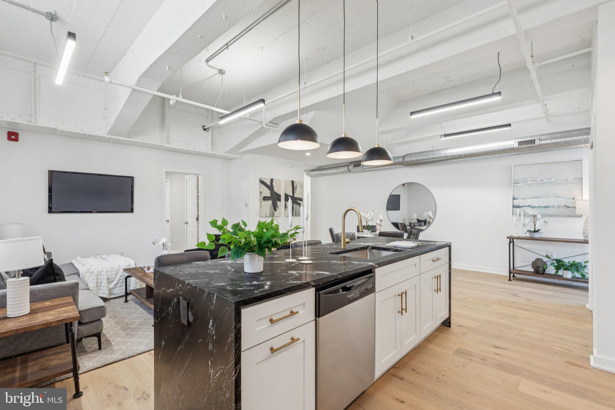 36 North Narberth Avenue, Unit 1C Narberth, PA 19072 - Photo 29 of 36 a kitchen with stainless steel appliances granite countertop a sink and cabinets