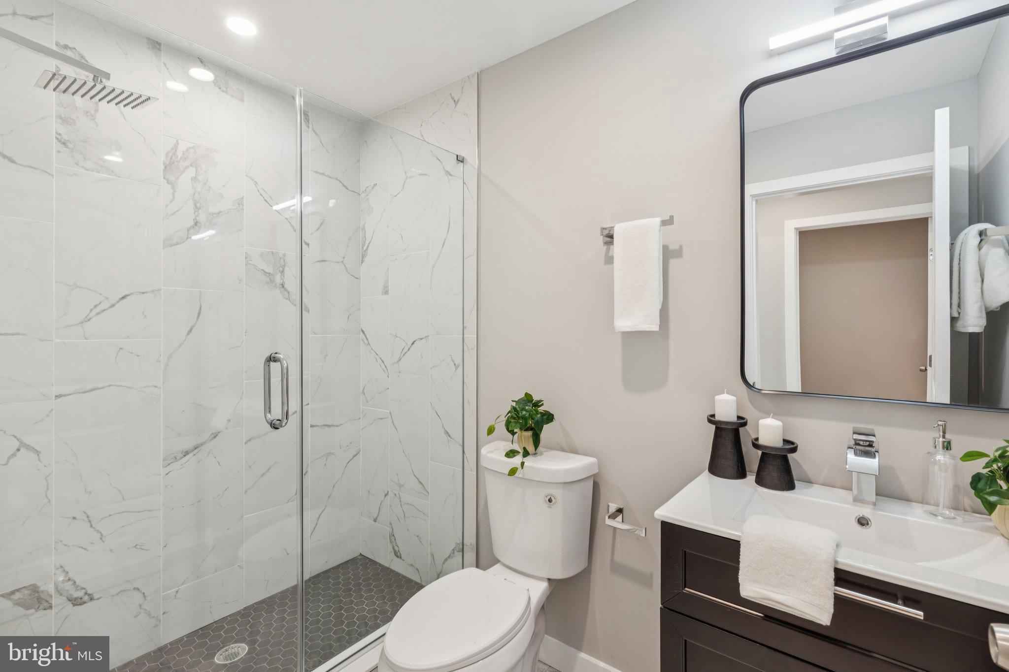 36 North Narberth Avenue, Unit 1C Narberth, PA 19072 - Photo 6 of 36 a bathroom with a sink a toilet and shower