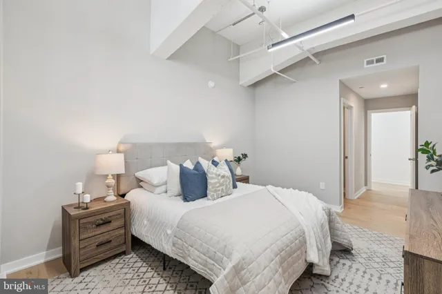 a bedroom with a bed and a lamp