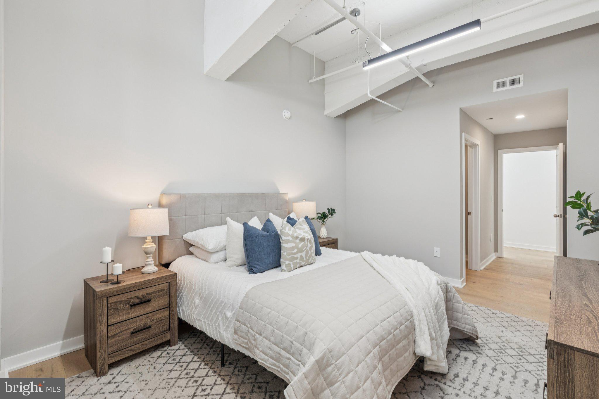 36 North Narberth Avenue, Unit 1C Narberth, PA 19072 - Photo 8 of 36 a bedroom with a bed and a lamp