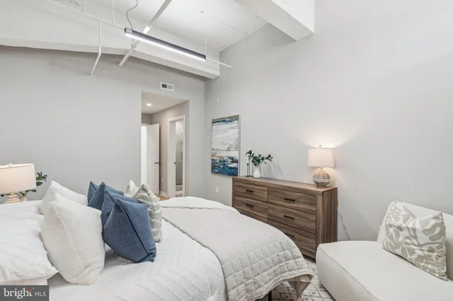 a bedroom with a bed and a dresser