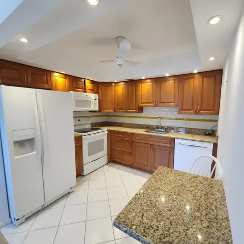 a kitchen with a sink appliances and cabinets