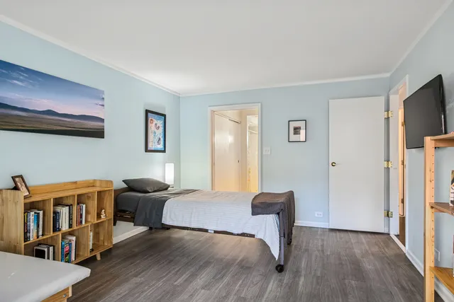 a bedroom with furniture and a wooden floor