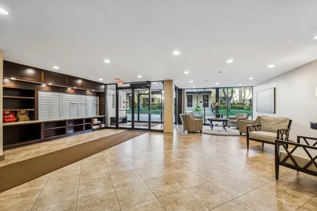 a lobby with furniture and floor to ceiling window