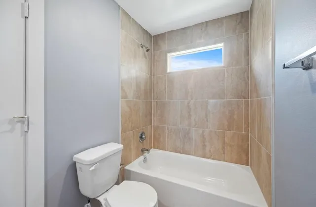 a bathroom with a toilet and a bathtub