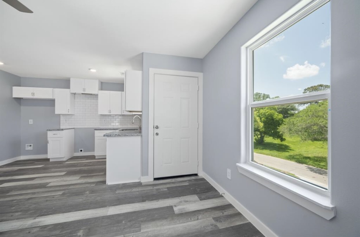 622 Maple Way Houston, TX 77015 - Photo 4 of 19 a view of a kitchen with a sink and dishwasher a refrigerator with wooden floor