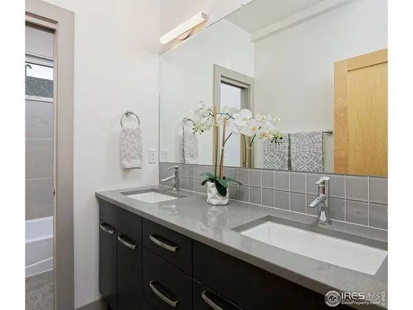 a bathroom with a double vanity sink and a mirror