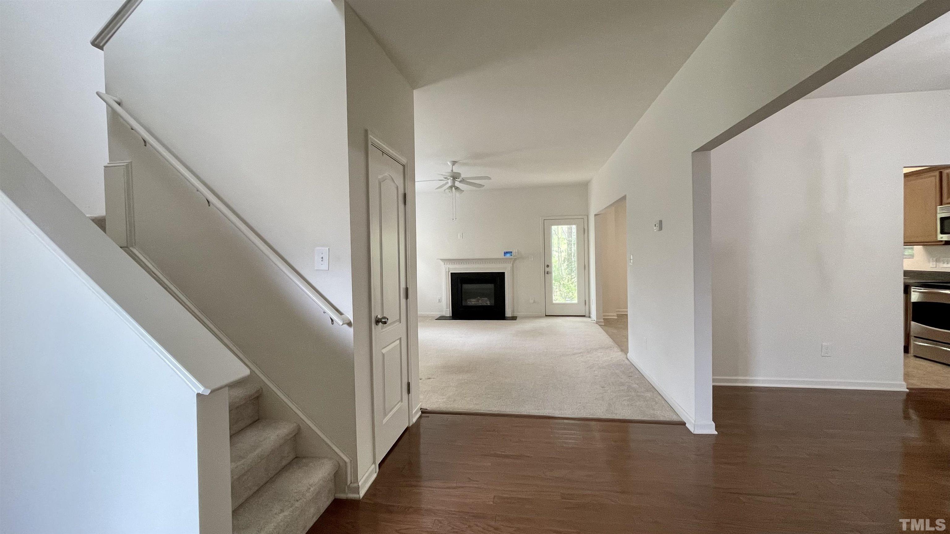 1120 Early Rise Street Raleigh, NC 27610 - Photo 8 of 33 a view of a hallway with wooden floor and staircase
