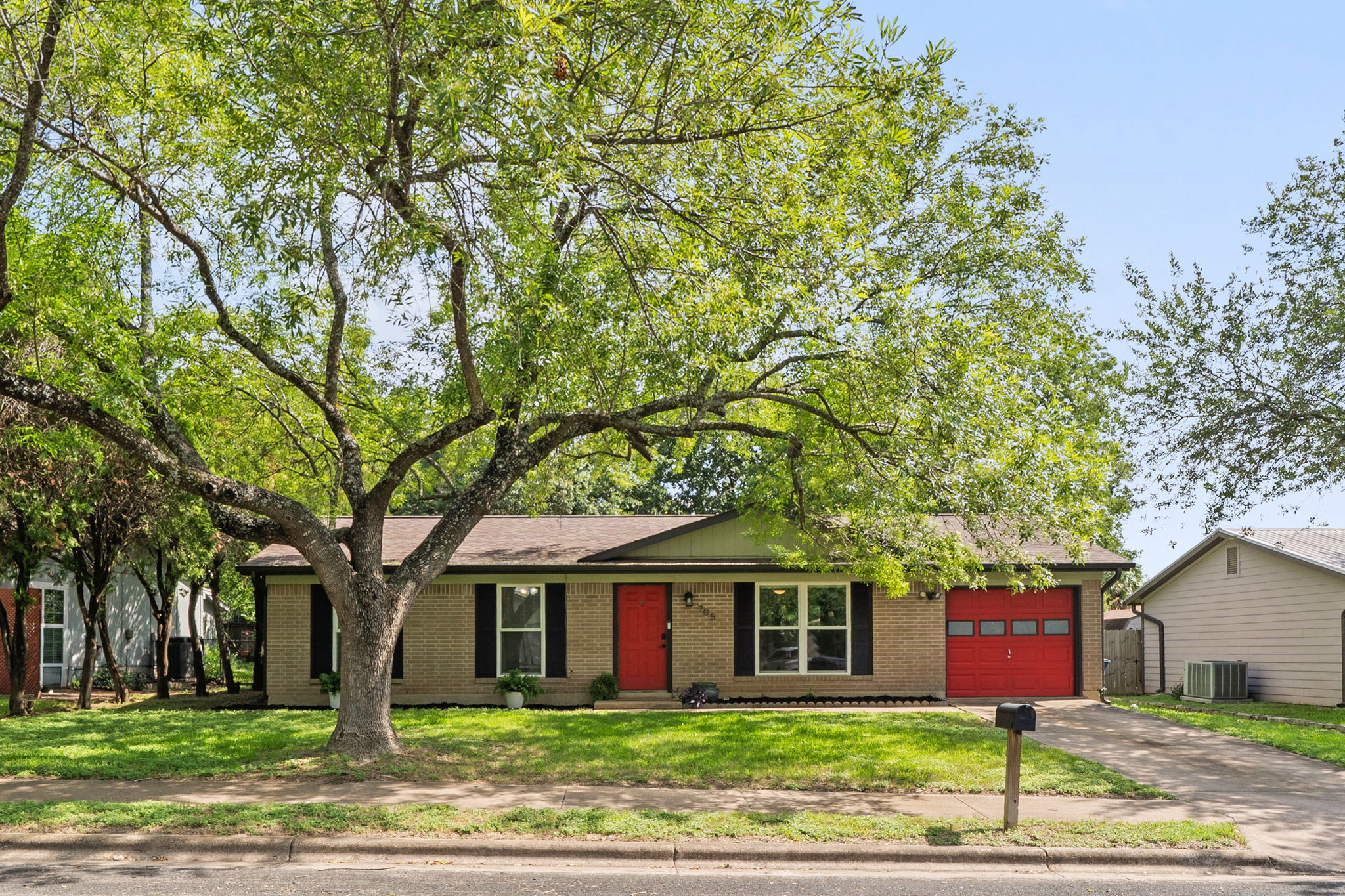 705 Dulwich Street Austin, TX 78748 - Photo 1 of 36 Brick facade with a vibrant red entry door creates inviting curb appeal.