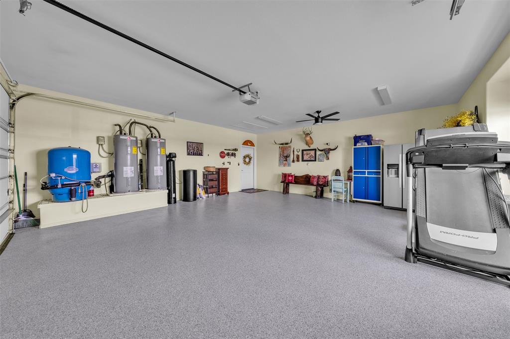 6628 Buffalo Ridge Circle Godley, TX 76044 - Photo 28 of 39 a view of a garage with furniture and a ceiling fan