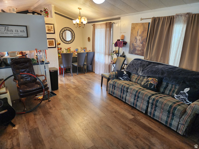 11362 Crescent Park Way, Unit 8 Sandy, UT 84070 - Photo 3 of 20 Living area featuring wood-type flooring and a chandelier