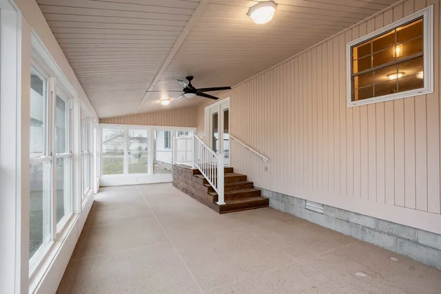 a living room with furniture and large windows