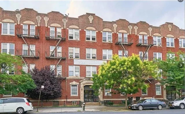 a view of a car parked in front of a building