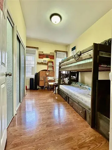 a bedroom with furniture and a wooden floor