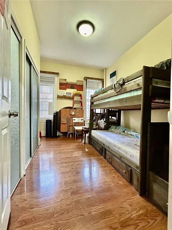 1953 65th Street, Unit 1D Brooklyn, NY 11204 - Photo 5 of 8 a bedroom with furniture and a wooden floor