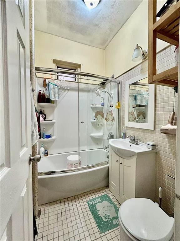1953 65th Street, Unit 1D Brooklyn, NY 11204 - Photo 7 of 8 a bathroom with a sink a toilet and shower