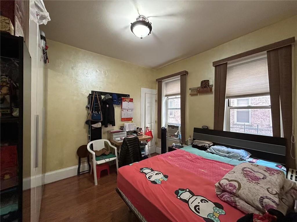 1953 65th Street, Unit 1D Brooklyn, NY 11204 - Photo 8 of 8 a bedroom with a bed and a dresser next to a window