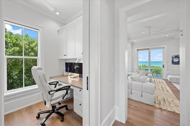 a view of a workspace with furniture and a window