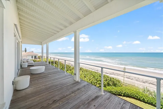 a view of a balcony with chair and wooden floor