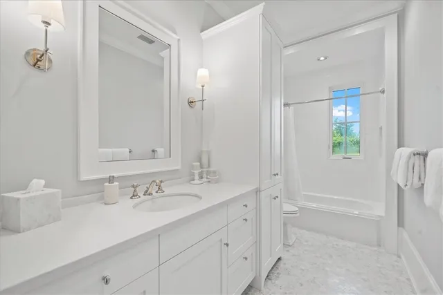 a bathroom with a sink vanity granite tub and shower