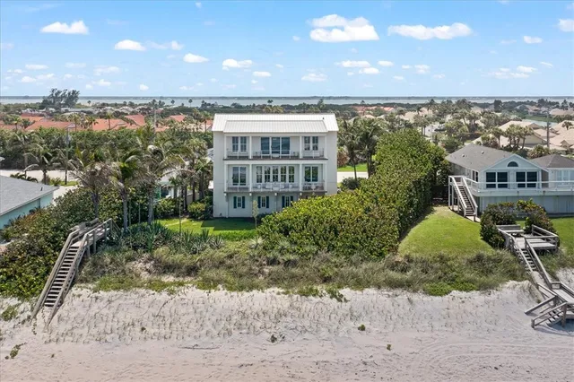 an aerial view of a house with a ocean view