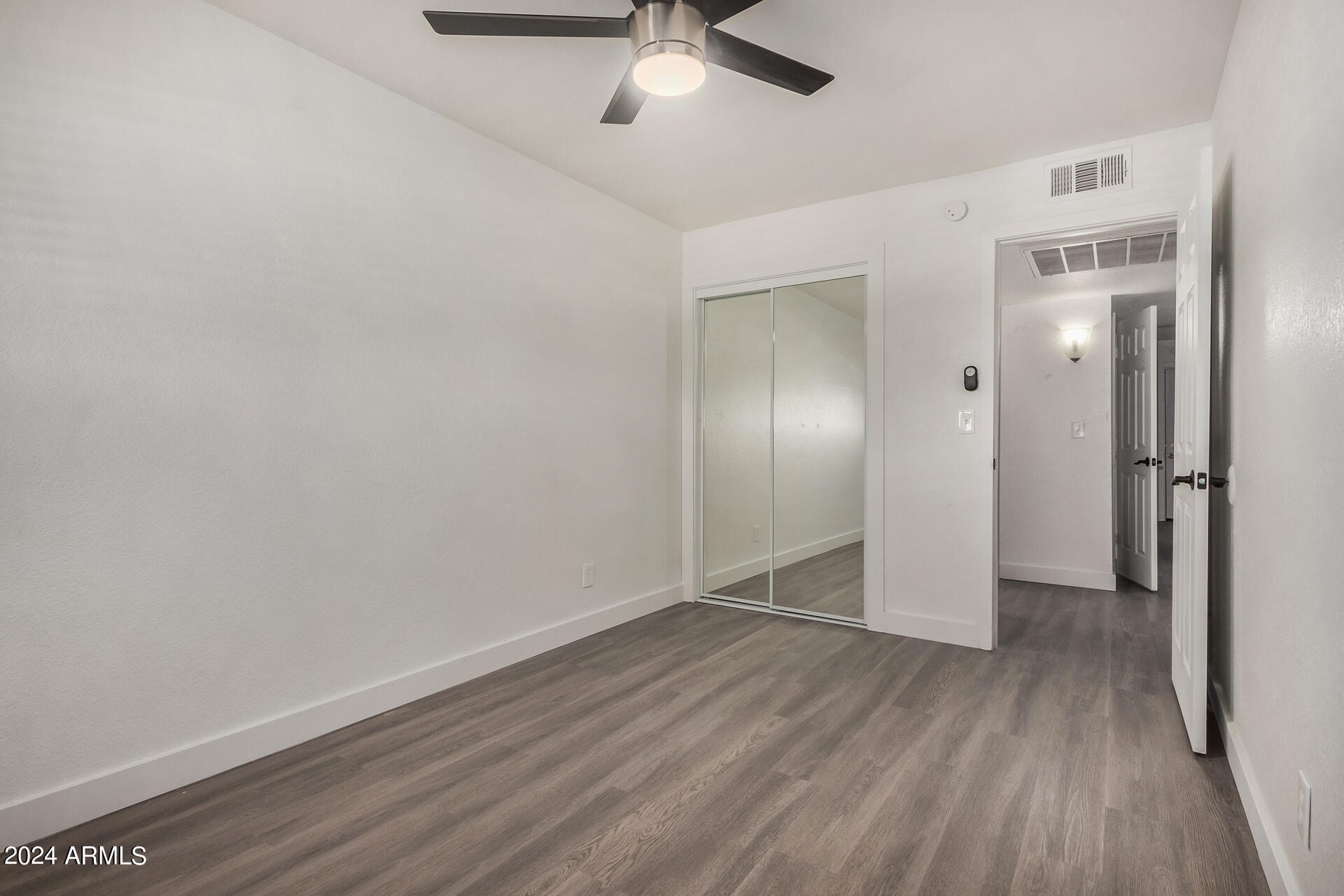 18202 Cave Creek Road, Unit 151 Phoenix, AZ 85032 - Photo 8 of 14 wooden floor in an empty room with a window