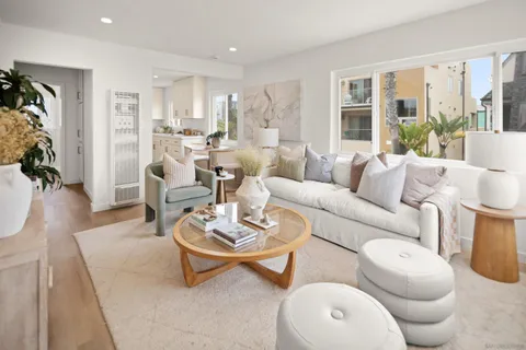 a living room with furniture a rug and a large window