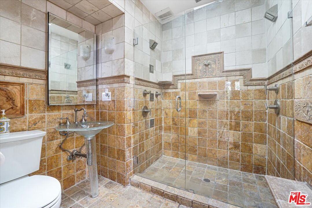 960 North Tigertail Road Los Angeles, CA 90049 - Photo 17 of 21 a bathroom with a shower and mirror