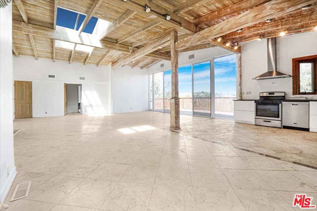 960 North Tigertail Road Los Angeles, CA 90049 - Photo 5 of 21 a view of a hall with wooden floor
