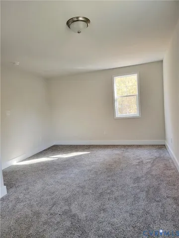 an empty room with a empty space and a window