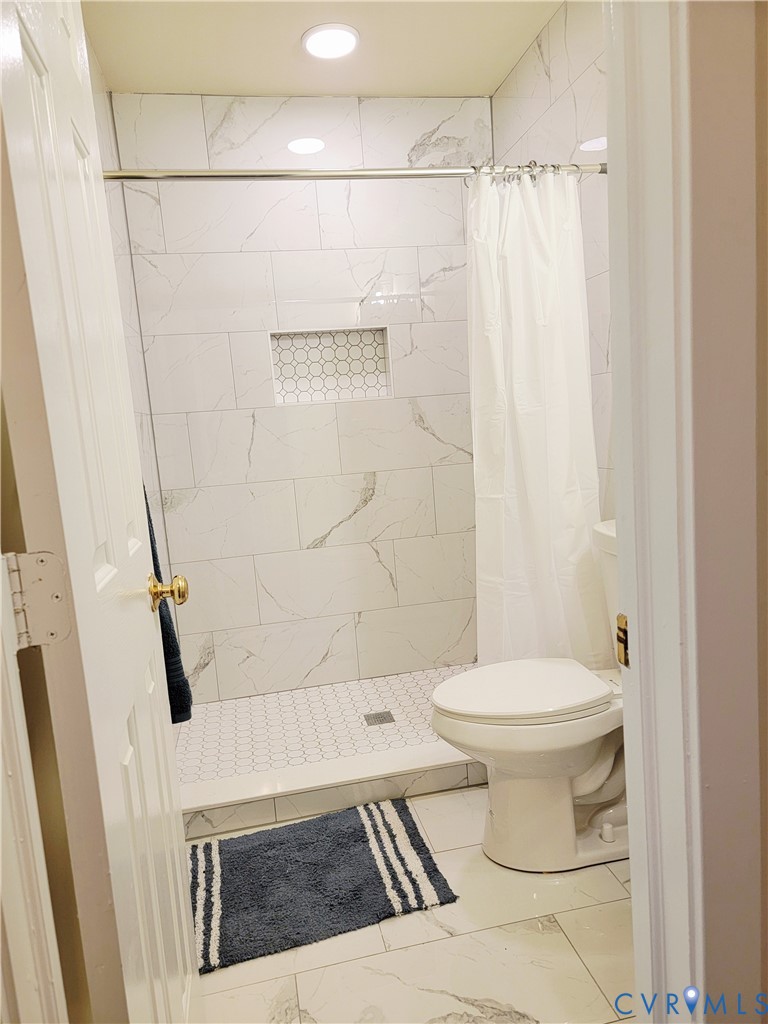 1205 Cox Road Blackstone, VA 23824 - Photo 14 of 29 a bathroom with a toilet and a shower