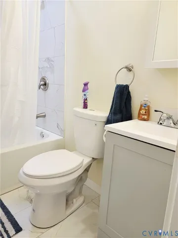 a white toilet sitting next to a bathroom sink