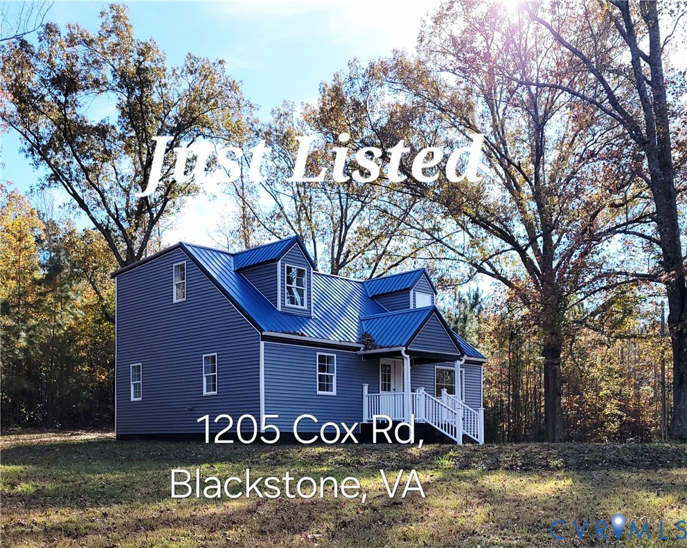1205 Cox Road Blackstone, VA 23824 - Photo 2 of 29 a front view of a house with yard and large trees