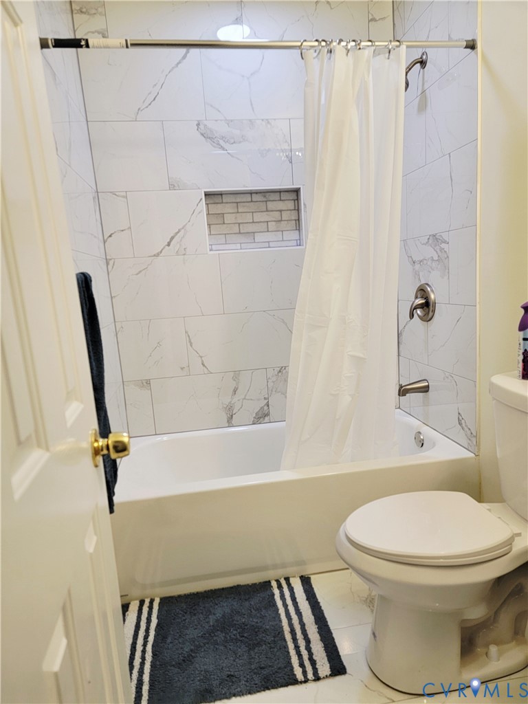 1205 Cox Road Blackstone, VA 23824 - Photo 23 of 29 a bathroom with a toilet and a shower