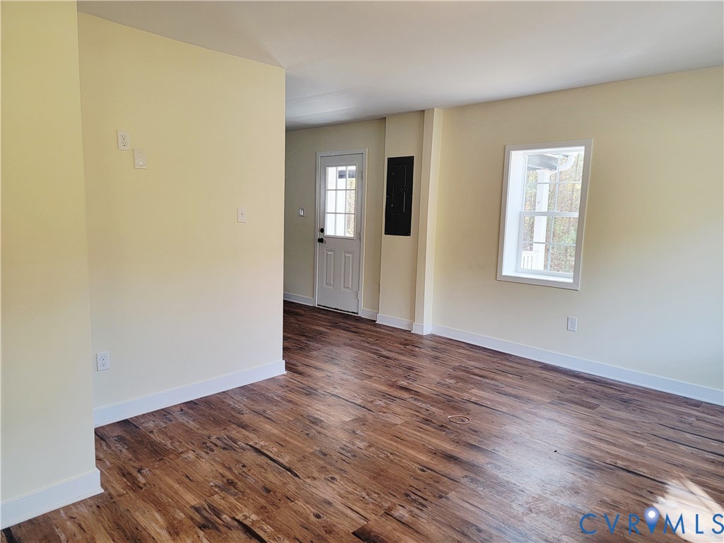 1205 Cox Road Blackstone, VA 23824 - Photo 28 of 29 an empty room with wooden floor and windows