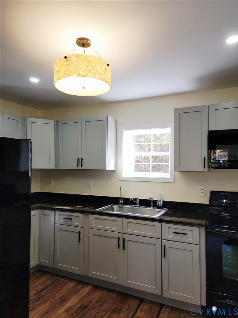 1205 Cox Road Blackstone, VA 23824 - Photo 8 of 29 a kitchen with granite countertop a sink a window stainless steel appliances and cabinets