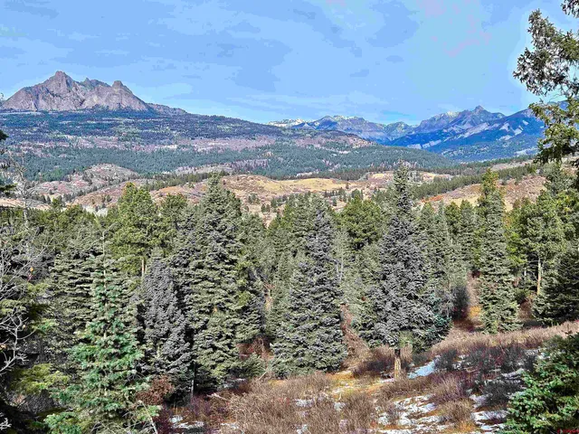 a view of a town with mountains in the background