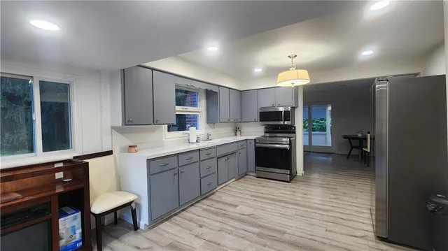a kitchen with a sink cabinets and stainless steel appliances