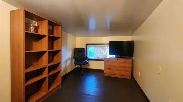 a view of a livingroom with furniture and a flat screen tv