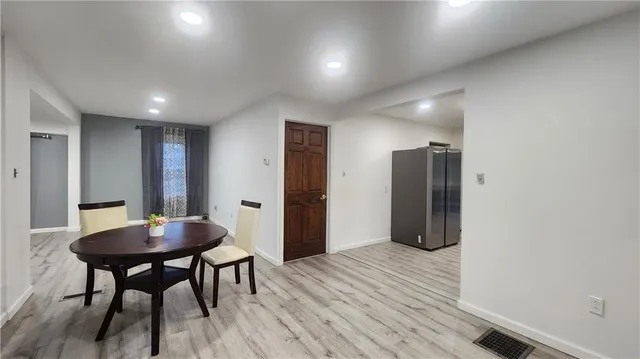 a view of a room with a table and chairs