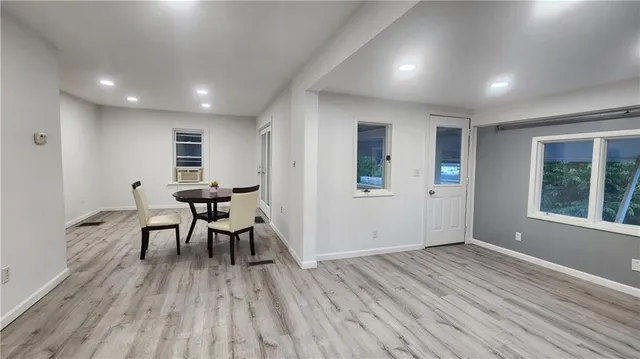 an empty room with wooden floor and furniture