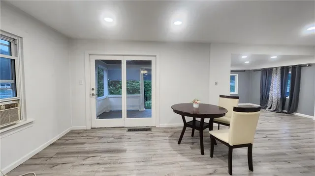 a view of a room with a table and chairs