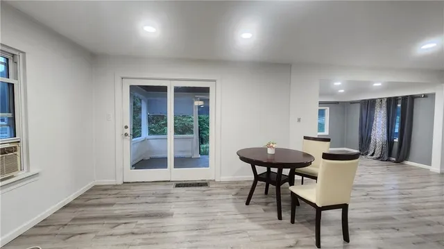a view of a room with furniture and wooden floor