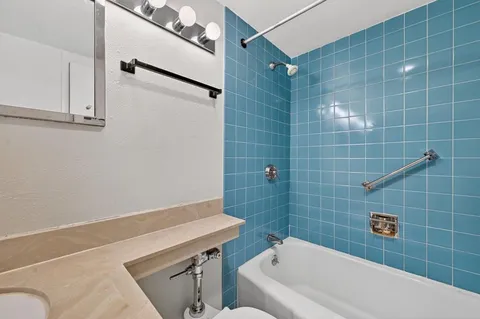 a bathroom with a bathtub and shower